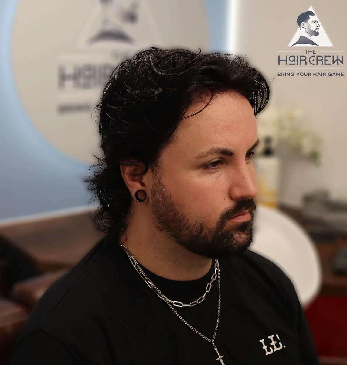 Side profile of the same client showing his hair system blended into his own hair